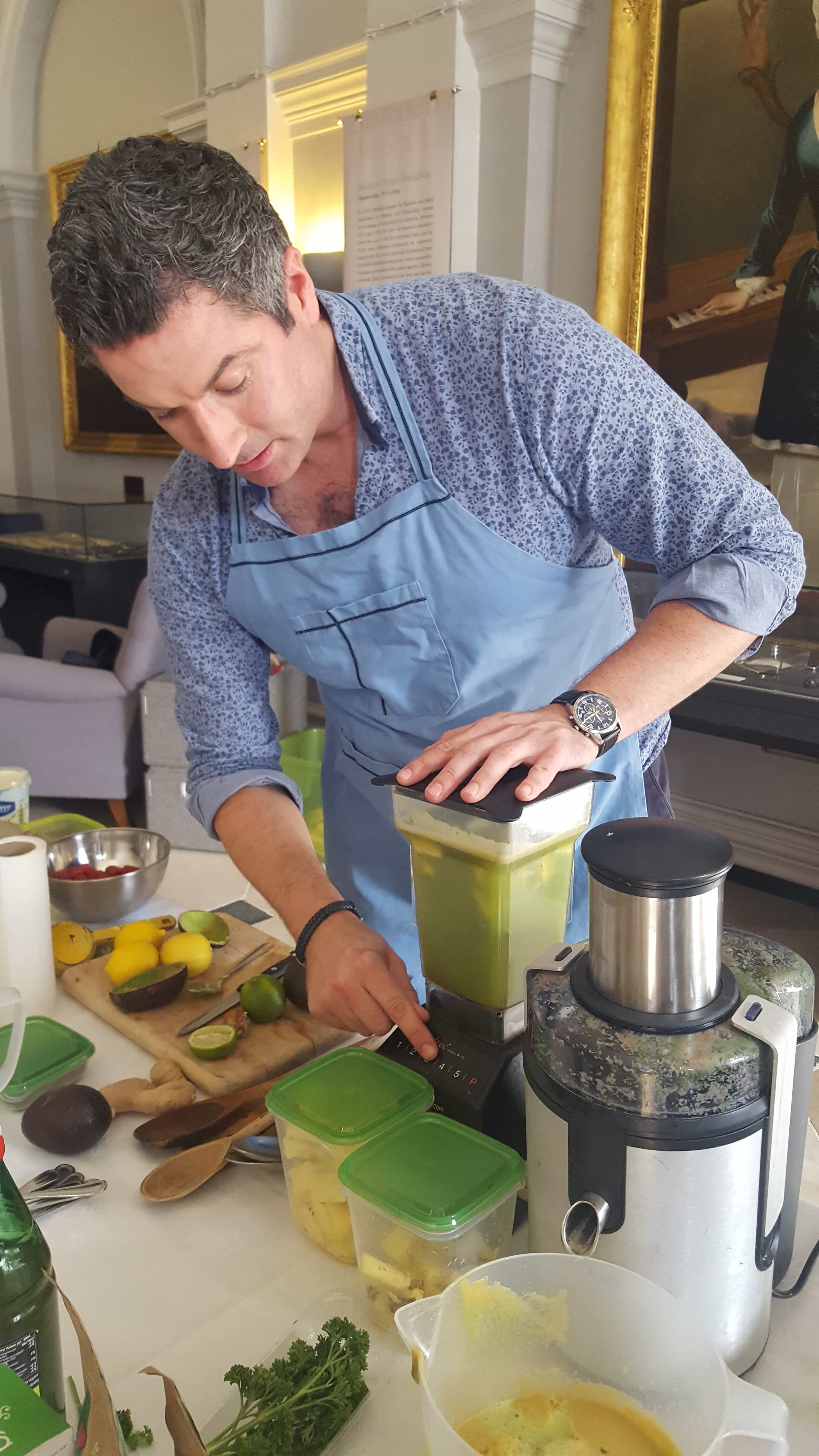 Oliver McCabe mixes a green smoothie at the Rotunda Employee Wellness Week
