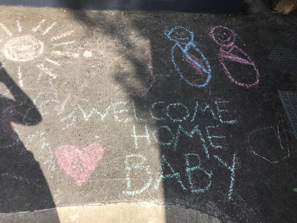 Greg and Yvonne’s neighbours welcomed them home with messages written in chalk on the road